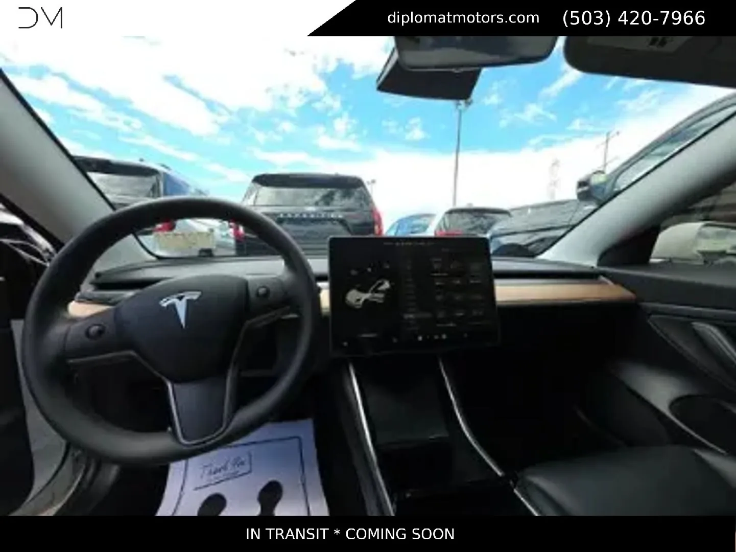 The steering wheel and screen inside a Tesla Model 3