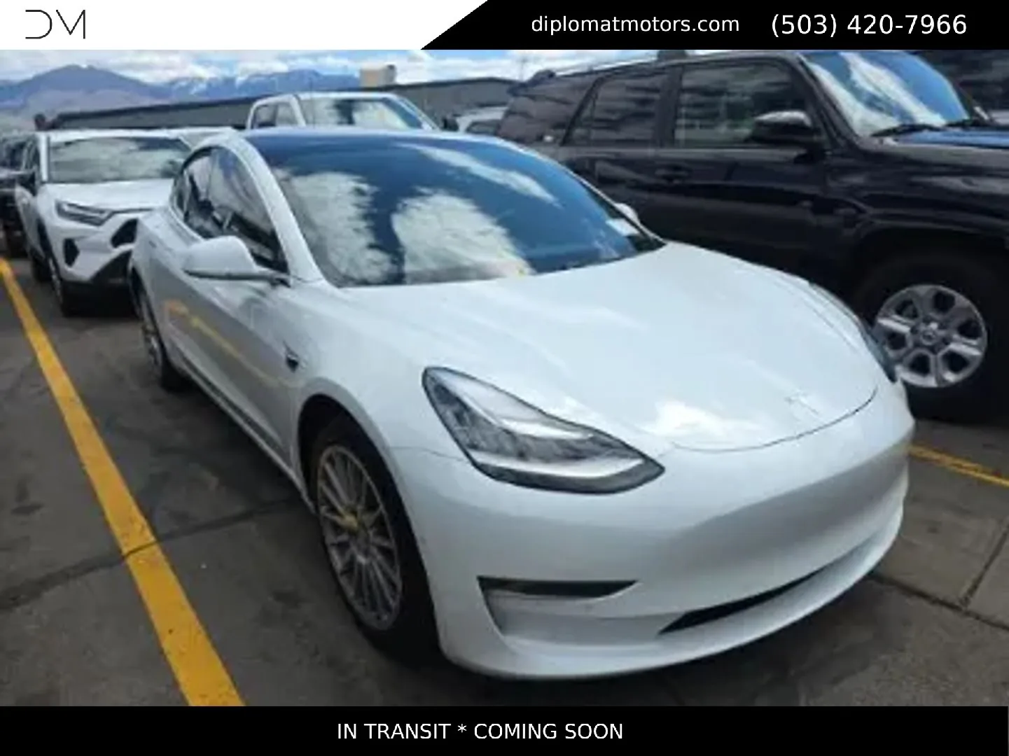 A white Tesla Model 3 outside on the Diplomat lot